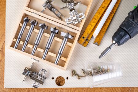Installation of furniture hinges in the kitchen cabinet door. Tools and furniture accessories needed...