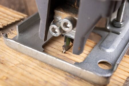 Jigsaw for cutting wood. Tools in a home workshop. Light background.の写真素材