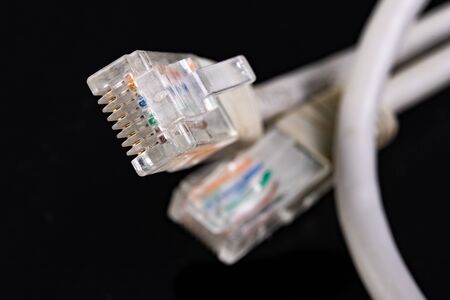 Mains plug mounted on the cable. Accessories for sending digital data. Dark background.