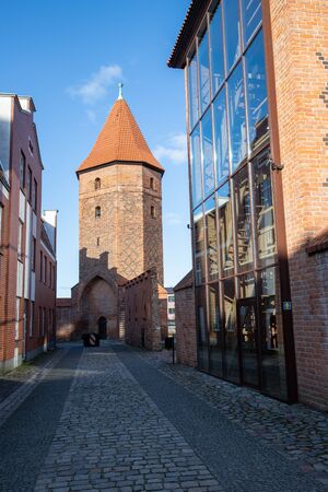 Lebork, pomorskie / Poland - February, 07, 2020: Old tower in the defensive walls in LÄbork. Old red brick buildings in Central Europe. Spring season.のeditorial素材