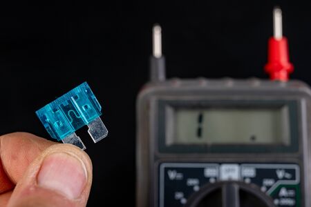 Measurement of resistance of car fuses with an electric meter. Checking the conductivity of...