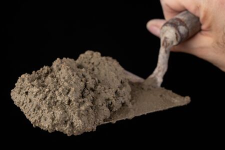 Trowel and mortar prepared for masonry. Accessories for building houses. Dark background.の写真素材