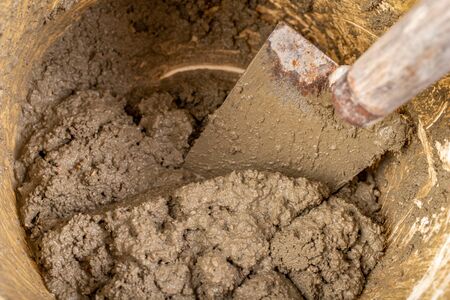Trowel and mortar prepared for masonry. Accessories for building houses. Light background.の写真素材