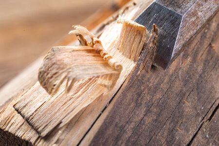 Chisel work in wood and raw wood shavings. Tools and accessories in a carpentry shop. Workplace...