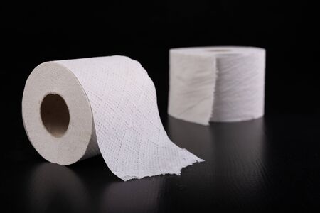 White toilet paper on a dark table. Articles for daily hygiene. Black background.の写真素材