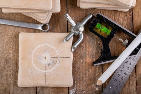 Drilling with a special drill in a ceramic tile. Tiling works during renovation. Workplace -...