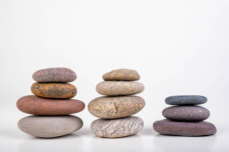 Round stones stacked. Stones found on the sea beach. Light background.
