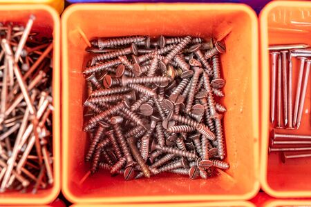Steel nails used in carpentry. Accessories for mounting and connecting in boxes. Light background.