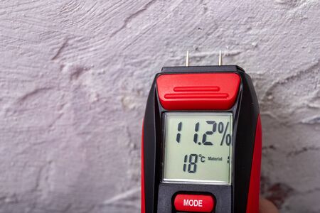 Plaster moisture measurement using an electronic meter. Measurements in the home workshop. Light...