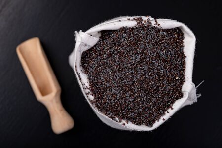 Tasty and clean poppy seeds in fabric bags. Ingredients for delicious desserts and other dish on the...