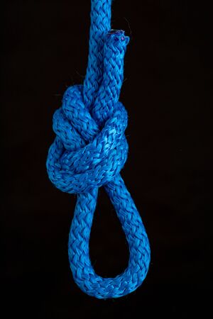 Nautical knot loop. Weave a thick rope. Dark background.の写真素材