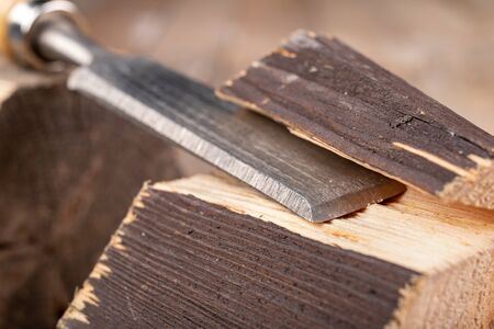 Work with a carpenter's chisel in pine wood. Small carpentry work in the home workshop. Light...