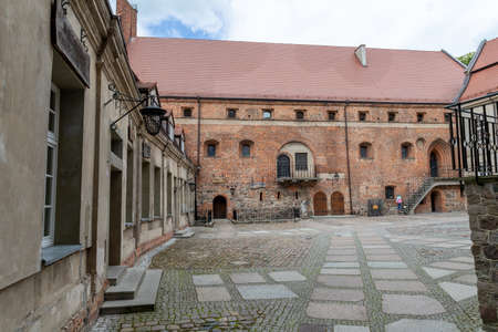 Swidwin, zachodniopomorskie / Poland - May, 29, 2020: Old knight's castle in the city center. Brick building in Central Europe. Spring season.のeditorial素材