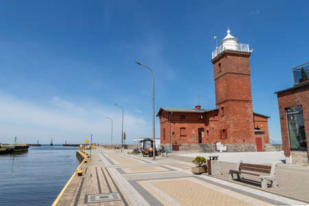 Darlowo, zachodni-pomorskie / Poland - June, 4, 2020: Old lighthouse built on the port quay. Big red brick building. Spring season.のeditorial素材