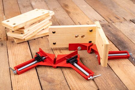 Joining wood using a carpentry clamp. Small carpentry work. Workplace - workshop.の写真素材