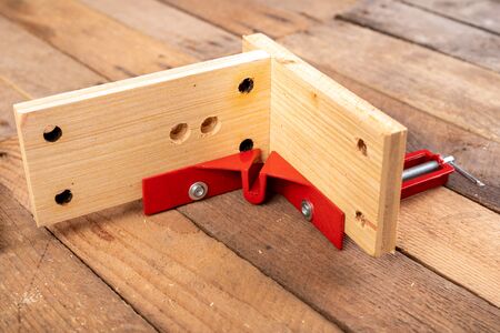 Joining wood using a carpentry clamp. Small carpentry work. Workplace - workshop.の写真素材