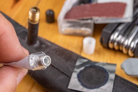 Gluing a bicycle detector in the workshop. Small works in the home garage. Workplace in the...