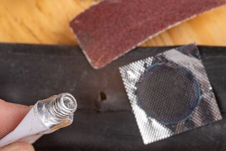 Gluing a bicycle detector in the workshop. Small works in the home garage. Workplace in the...
