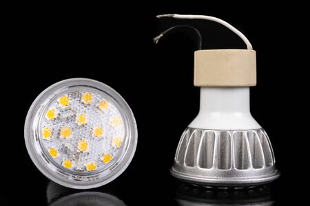 LED bulbs on a dark table. LED lighting and connectors for the energy source. Black background.の写真素材