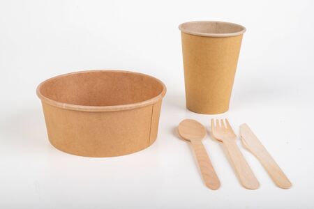 Wooden cutlery and disposable container. Accessories for a barbecue in the home garden. Light background.の写真素材