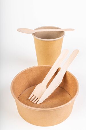 Wooden cutlery and disposable container. Accessories for a barbecue in the home garden. Light background.の写真素材