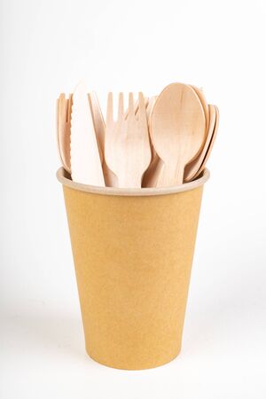 Wooden cutlery and disposable container. Accessories for a barbecue in the home garden. Light background.の写真素材