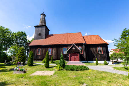 Gwiezdzin, pomorskie / Poland-June 17, 2020 .: Wooden church in Central Europe. Catholic temple built of wood. Summer season.のeditorial素材