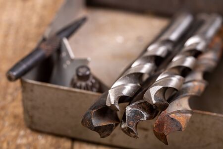 Metal drill bits and locksmith accessories. Accessories in a home workshop. Workplace garage at home.の写真素材