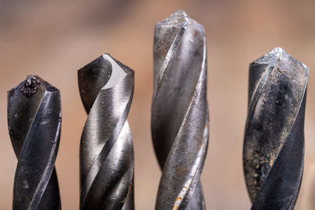 Metal drill bits placed in a stand. Accessories in a home workshop. Workplace garage at home.の写真素材