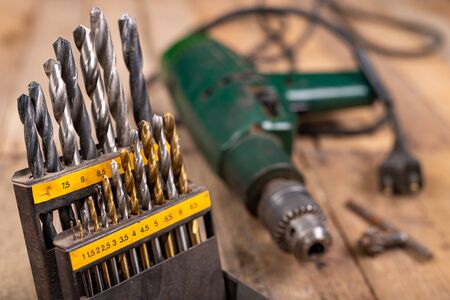 Metal drill bits. Accessories in a home workshop. Workplace garage at home.の写真素材