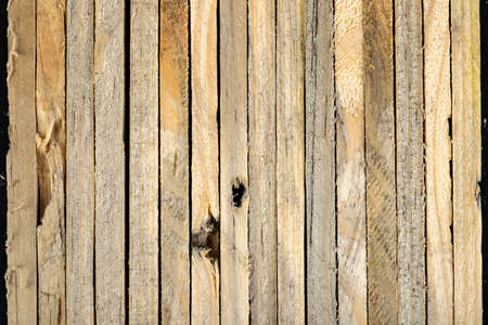 Wooden raw slats arranged on the countertop. Materials for carpenters to build furniture. Dark...