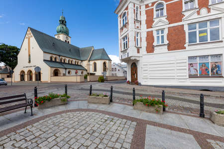 Czluchow, pomorskie / Poland-July, 12, 2020: Catholic temple in a small town. A church in the center of the city in Pomerania. Summer season.