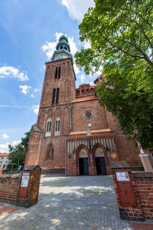 Chelmza, kujawsko pomorskie / Poland-July, 15, 2020: A historic church in a small town in Central Europe. Christian temple in the city center. Summer season.のeditorial素材