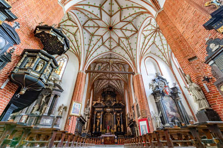 Chelmza, kujawsko pomorskie / Poland-July, 15, 2020: Historic interiors of a large Gothic church. Christian temple in the city center. Summer season.のeditorial素材