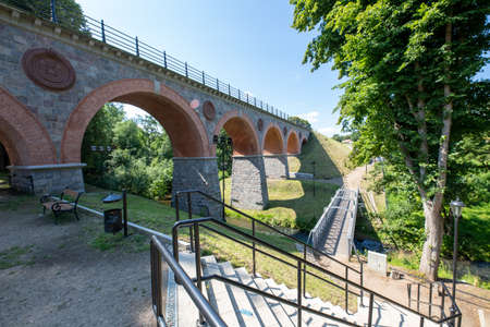 Bytow, pomorskie / Poland - July, 17, 2020: Old bridge built of stones and bricks. Railway crossing over a small river. Summer season.のeditorial素材
