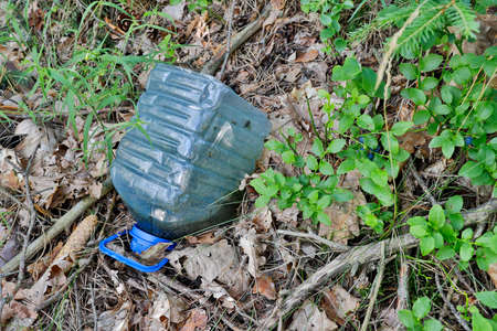 Left plastic garbage in the forest. A littered forest in Central Europe. Summer season.の写真素材