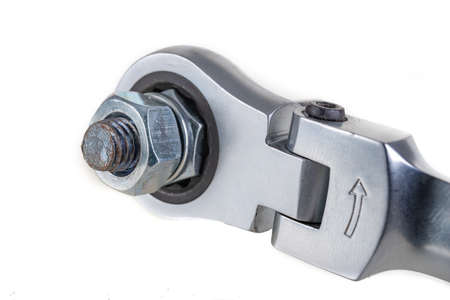 Metal bolts, nuts and a wrench for tightening. Accessories for mounting metal elements. Light background.の写真素材