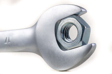 Wrench and metal nut. Accessories for mounting metal elements. Light background.の写真素材