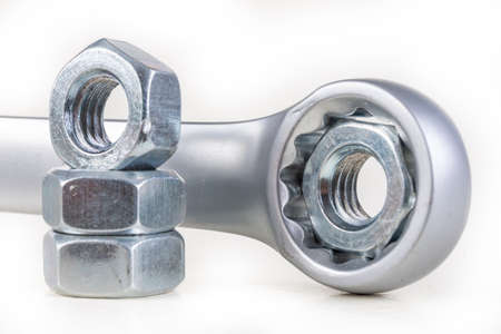 Wrench and metal nuts. Accessories for mounting metal elements. Light background.の写真素材