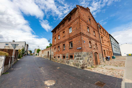 Debrzno, pomorskie / Poland - July, 23, 2020: Old tenement house built of red brick. A run down building in a small town. Summer season.のeditorial素材