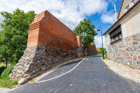 Debrzno, pomorskie / Poland - July, 23, 2020: Defensive walls built of red brick. Medieval buildings in a small town. Summer season.のeditorial素材