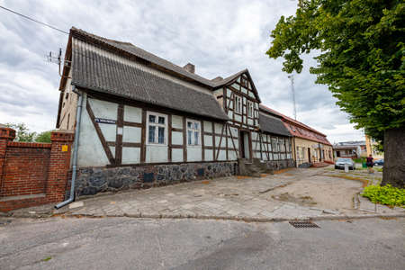 Lobzenica, wielkopolskie / Poland - July, 23, 2020: An old house with a Prussian wall. Tenement house in the city center. Summer season.のeditorial素材