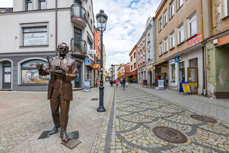 Koscierzyna, pomorskie / Poland - July, 24, 2020: A fountain on the market square in a small town. Bronze monument in the city center. Summer season.のeditorial素材
