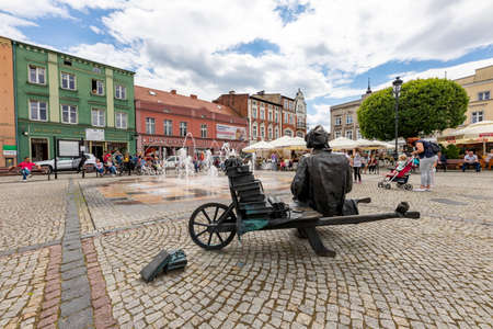 Koscierzyna, pomorskie / Poland - July, 24, 2020: A fountain on the market square in a small town. Bronze monument in the city center. Summer season.のeditorial素材