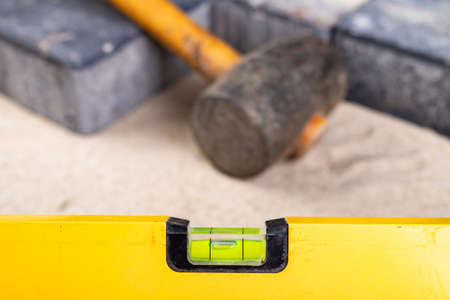 Laying paving stones on sand. Minor paving work in a home environment. Garden workplace.の写真素材