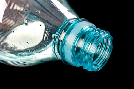 The neck of a plastic bottle. Water storage container. Dark background.の写真素材