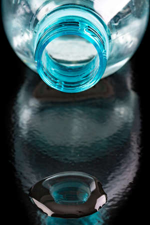 Plastic bottle neck and water. Water storage container. Dark background.の写真素材