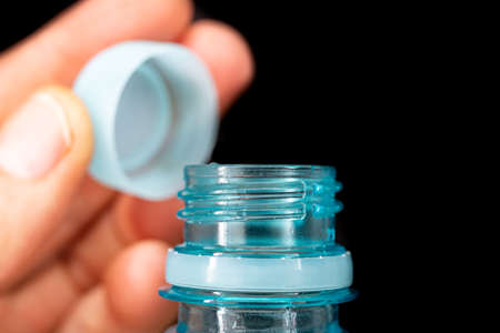 Bottle neck and plastic cap. Water storage container. Dark background.の写真素材
