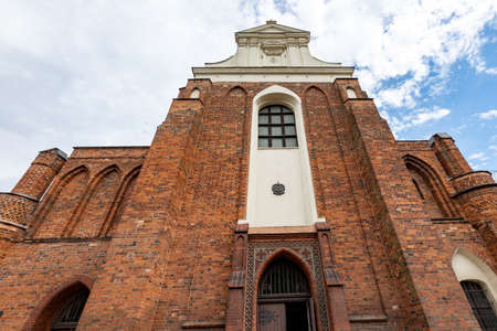 Koronowo, kujawskopomorskie / Poland - July, 28, 2020: Old monastery building in Koronowo. A Christian temple built of red brick. Summer season.のeditorial素材