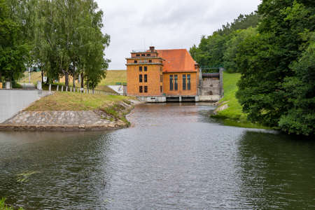 Lapino, pomorskie / Poland - July, 31, 2020: Old hydropower plant. Hydrotechnical structure in Central Europe. Summer season.のeditorial素材